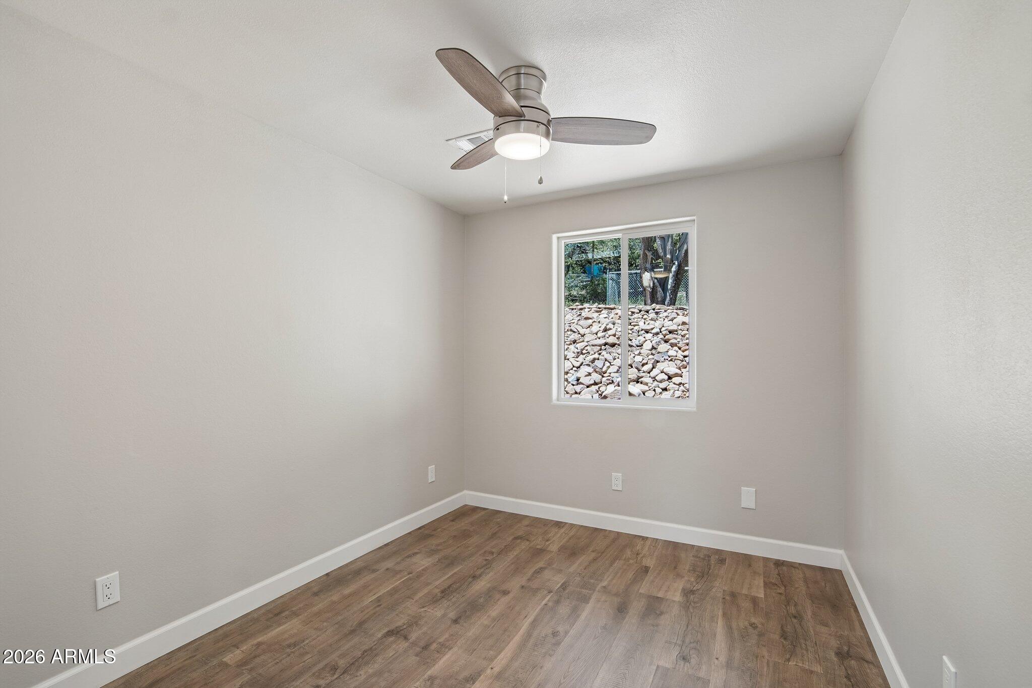 8324 Fossil Creek Road Pine, AZ 85544 - Photo 17 of 29 an empty room with a window and ceiling fan