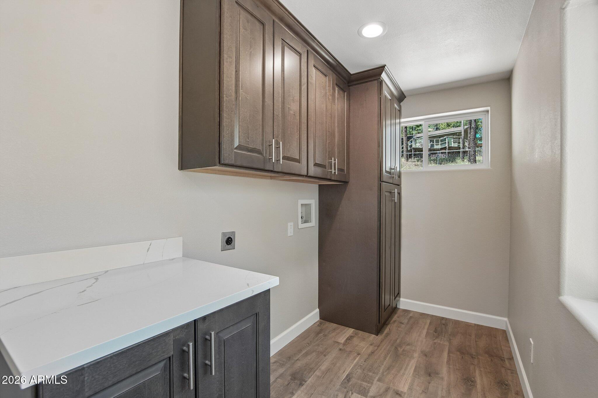8324 Fossil Creek Road Pine, AZ 85544 - Photo 23 of 29 a kitchen with a wooden floor and cabinets