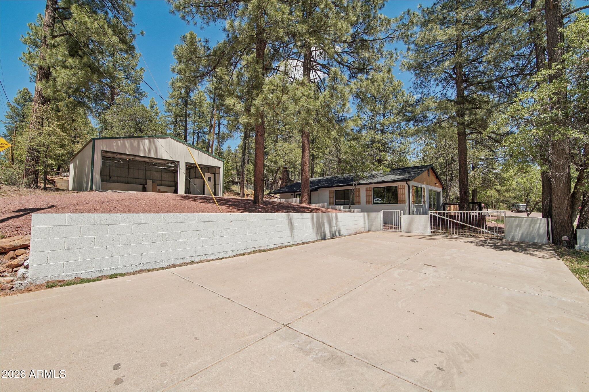 8324 Fossil Creek Road Pine, AZ 85544 - Photo 26 of 29 a front view of a house with a yard and trees