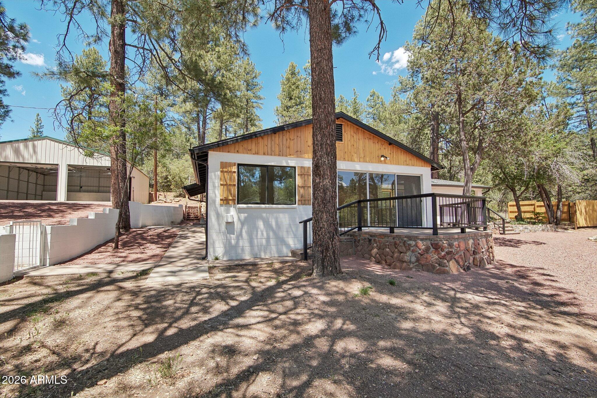 8324 Fossil Creek Road Pine, AZ 85544 - Photo 3 of 29 a view of a house with a yard and large tree