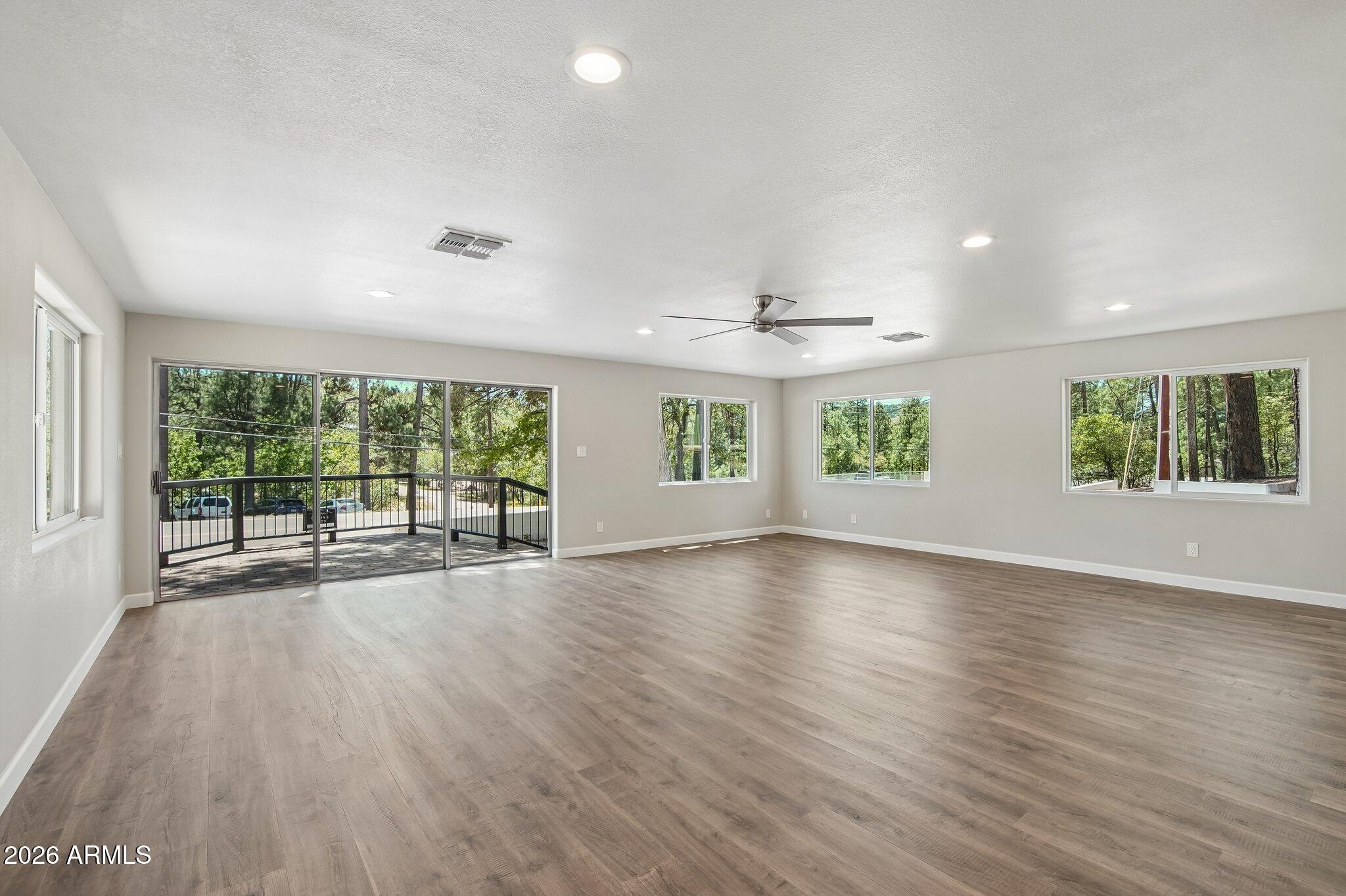 8324 Fossil Creek Road Pine, AZ 85544 - Photo 6 of 29 a view of an empty room with wooden floor and a window