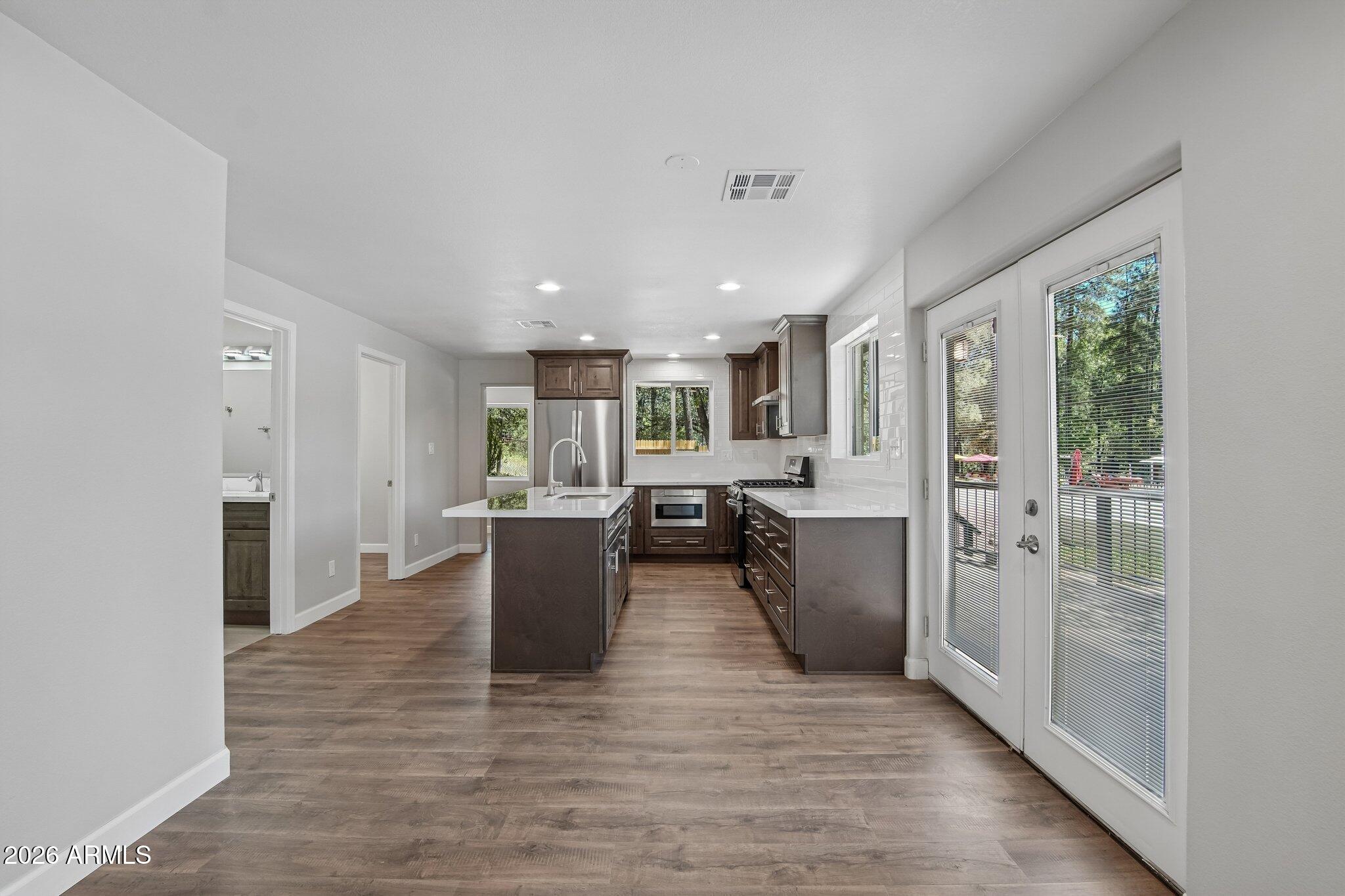 8324 Fossil Creek Road Pine, AZ 85544 - Photo 9 of 29 a view of a living room kitchen and a wooden floor