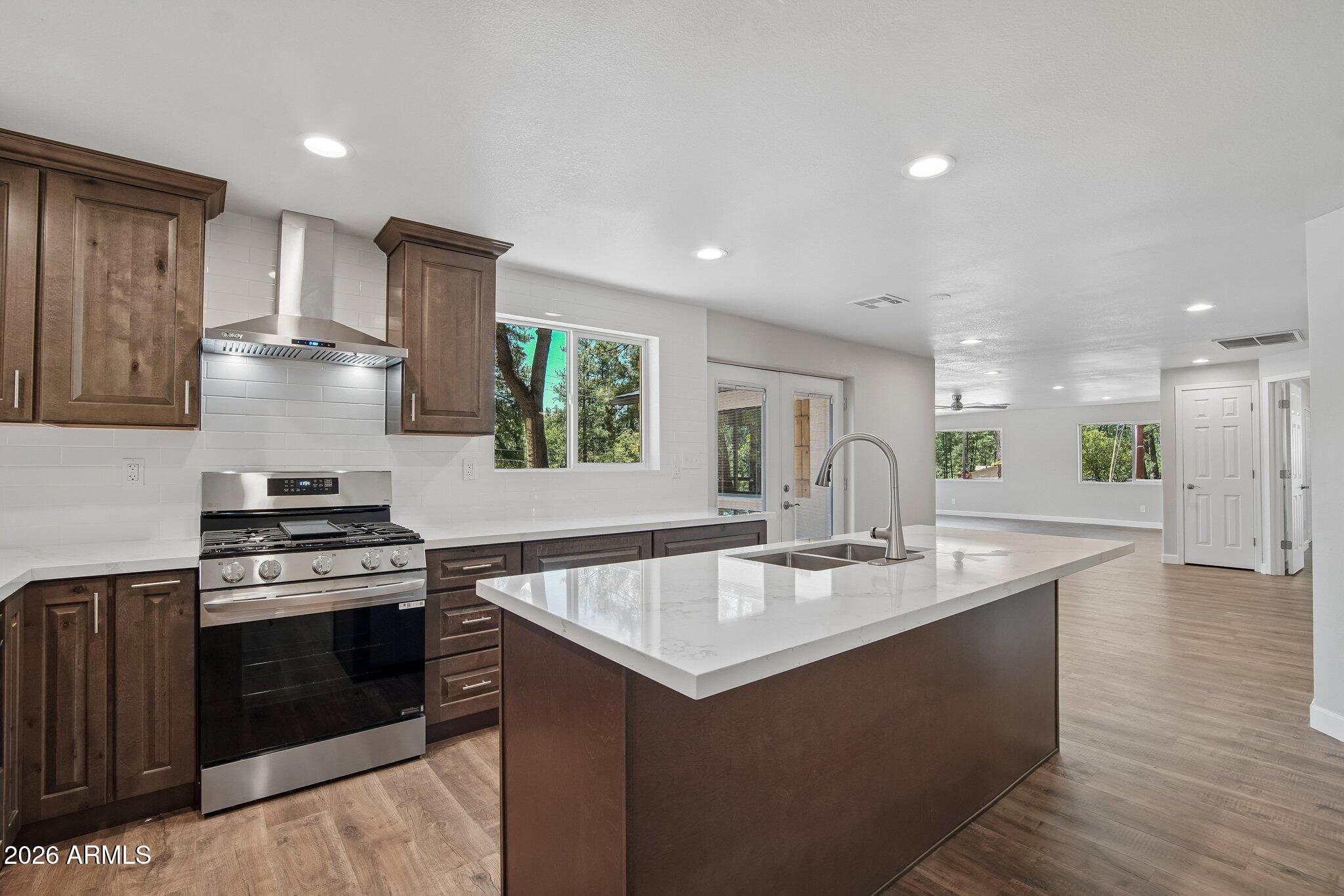 8324 Fossil Creek Road Pine, AZ 85544 - Photo 10 of 29 a kitchen with a stove a sink and a refrigerator