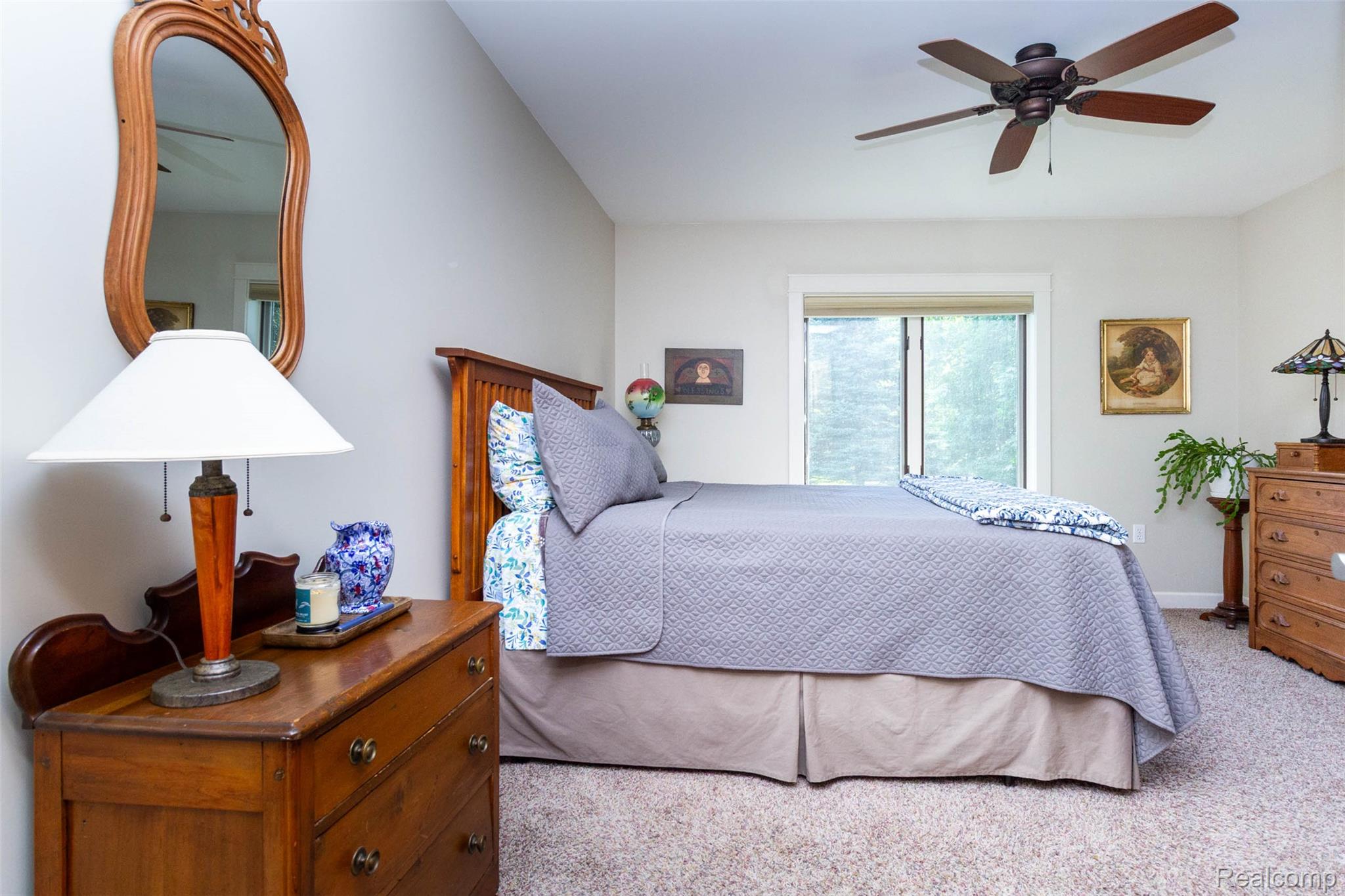 9887 Hadley Road Clarkston, MI 48348 - Photo 24 of 56 Carpeted bedroom with a dark wood-finish ceiling fan, neutral wall tones, and a large window featuring white trim