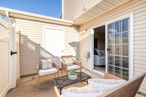 a view of a patio with couches chairs and potted plants