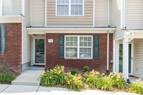 a front view of a brick house many windows