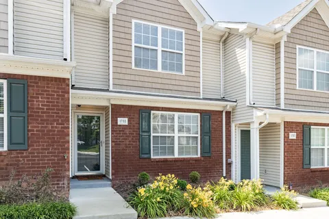 a front view of a brick house many windows