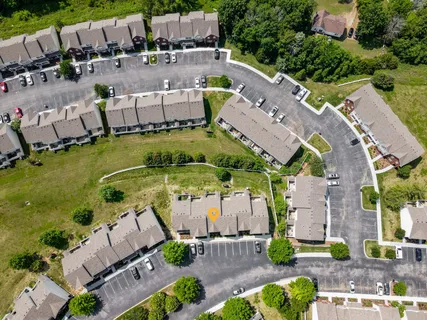 an aerial view of a house with a garden and lake view
