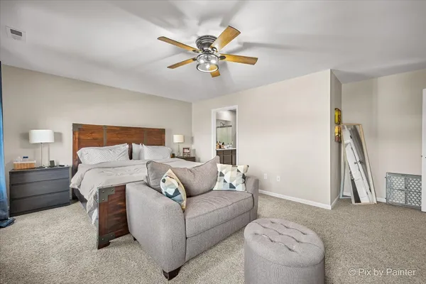 a bed room with a bed and a ceiling fan