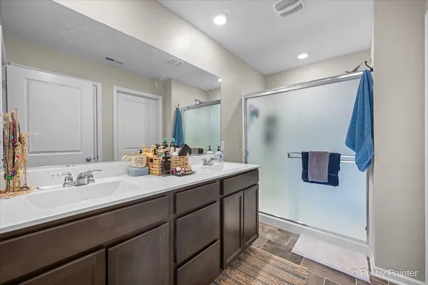 a bathroom with a double vanity sink and mirror
