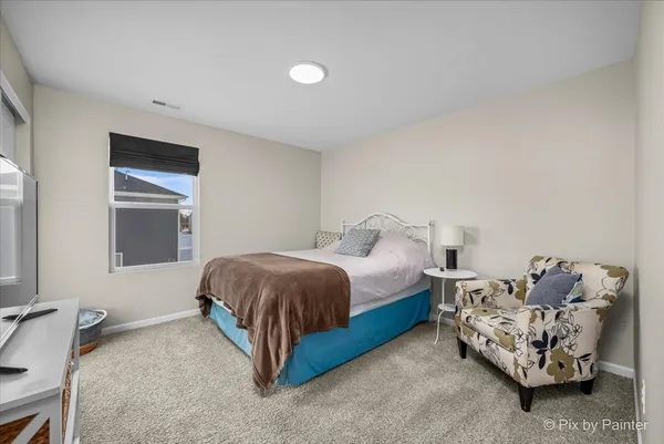 a spacious bedroom with a bed and a window