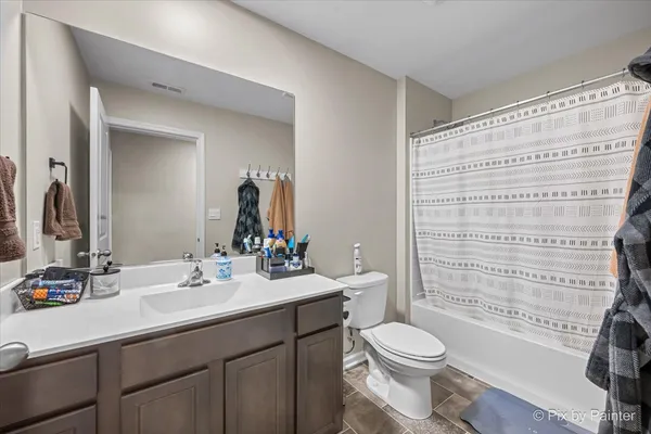 a bathroom with a sink a toilet a mirror and shower