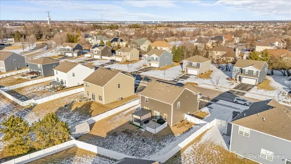 an aerial view of a house with a ocean