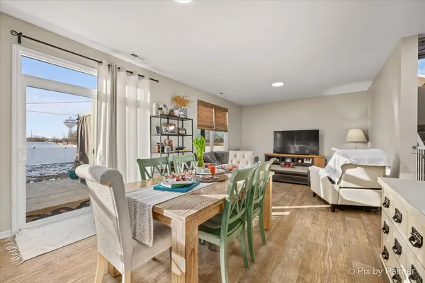 a view of a dining room with furniture window and wooden floor