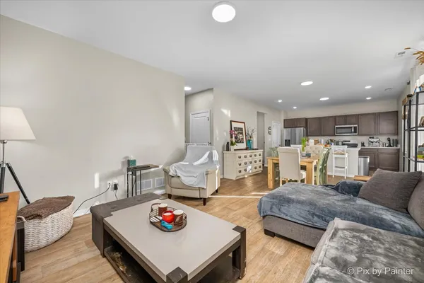 a living room with furniture and kitchen view