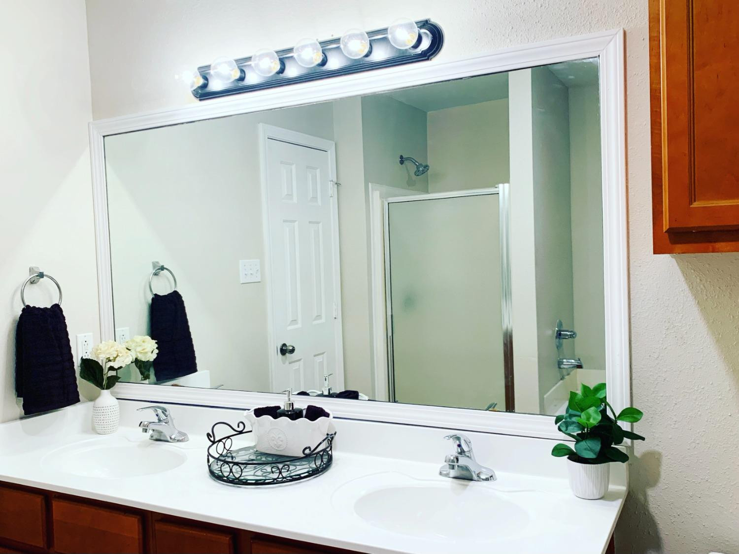 9807 Juneau Avenue Lubbock, TX 79424 - Photo 12 of 22 a bathroom with a sink and a mirror