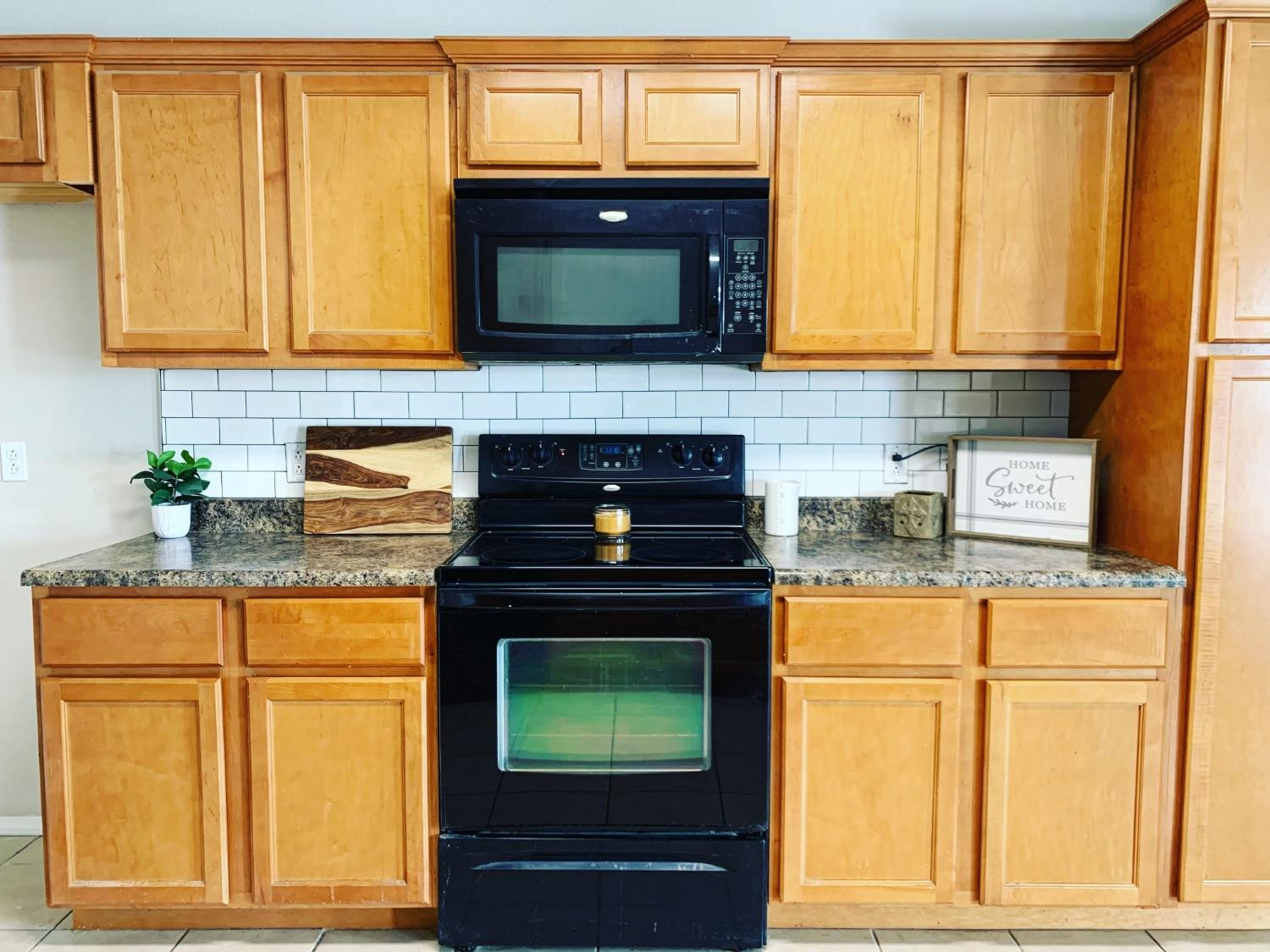 9807 Juneau Avenue Lubbock, TX 79424 - Photo 8 of 22 a kitchen with granite countertop cabinets stainless steel appliances and a counter space