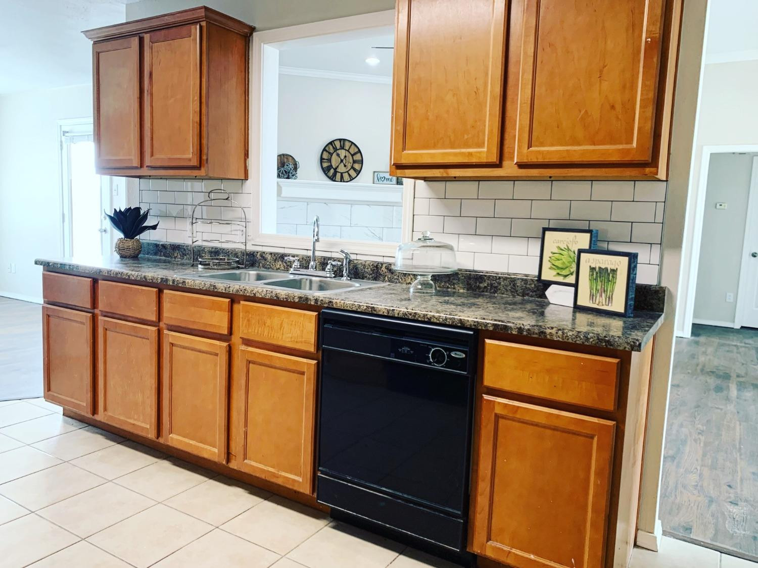 9807 Juneau Avenue Lubbock, TX 79424 - Photo 9 of 22 a kitchen with granite countertop cabinets and window