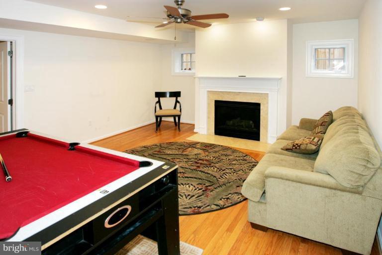 7105 Exfair Road Bethesda, MD 20814 - Photo 12 of 24 a living room with furniture pool table and a fireplace