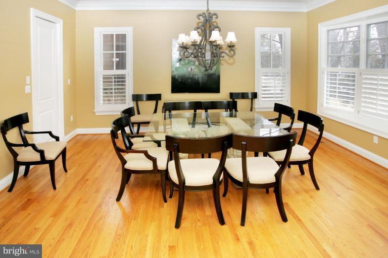 7105 Exfair Road Bethesda, MD 20814 - Photo 14 of 24 a view of a dining room with furniture and wooden floor