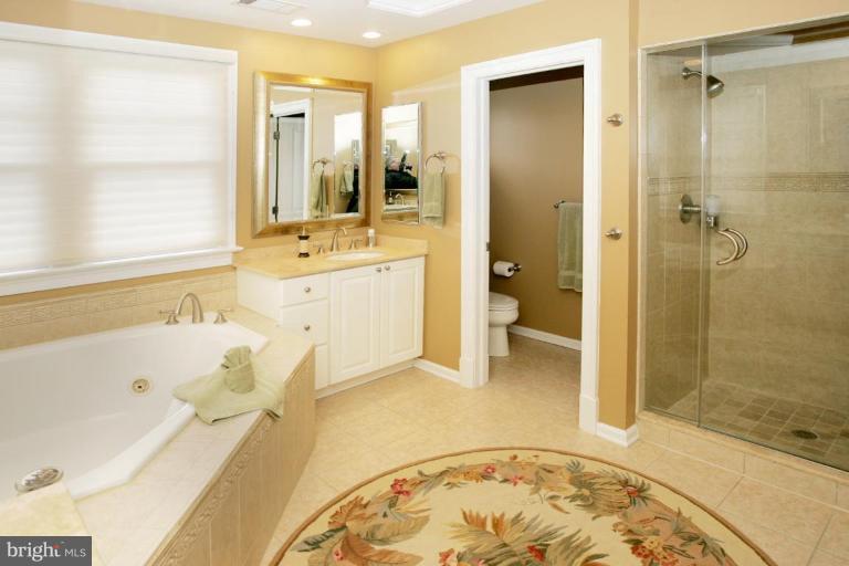 7105 Exfair Road Bethesda, MD 20814 - Photo 16 of 24 a bathroom with a tub a sink and a shower