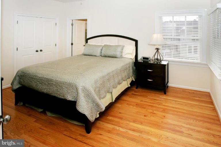 7105 Exfair Road Bethesda, MD 20814 - Photo 17 of 24 a large bed sitting in a bedroom next to a window