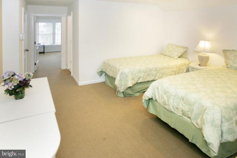 7105 Exfair Road Bethesda, MD 20814 - Photo 19 of 24 a bedroom with two beds and potted plants