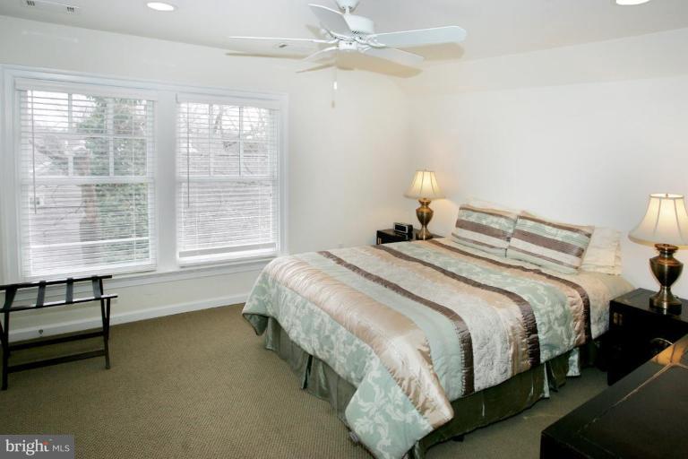 7105 Exfair Road Bethesda, MD 20814 - Photo 20 of 24 a bedroom with a bed and a chandelier