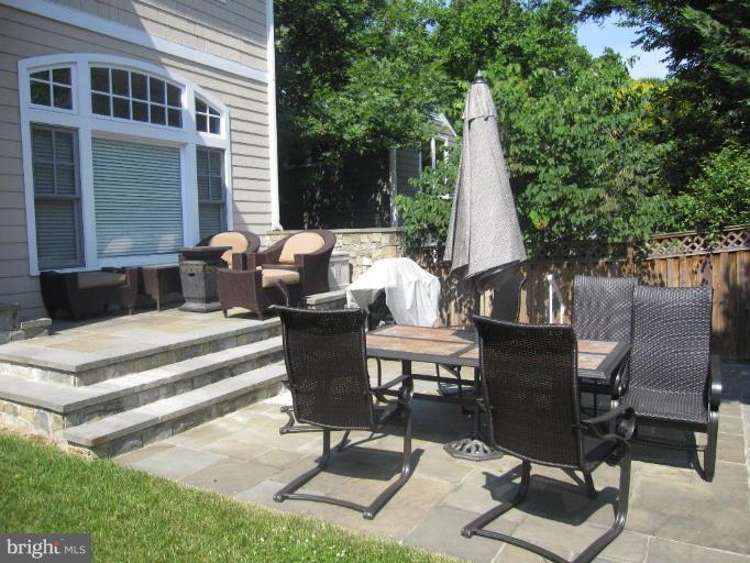 7105 Exfair Road Bethesda, MD 20814 - Photo 6 of 24 a view of a patio with table and chairs and floor to ceiling window