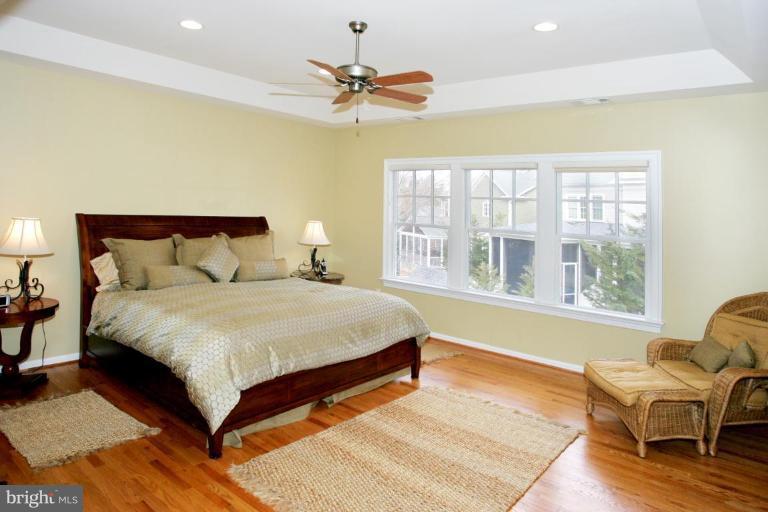 7105 Exfair Road Bethesda, MD 20814 - Photo 9 of 24 a bedroom with a bed and wooden floor