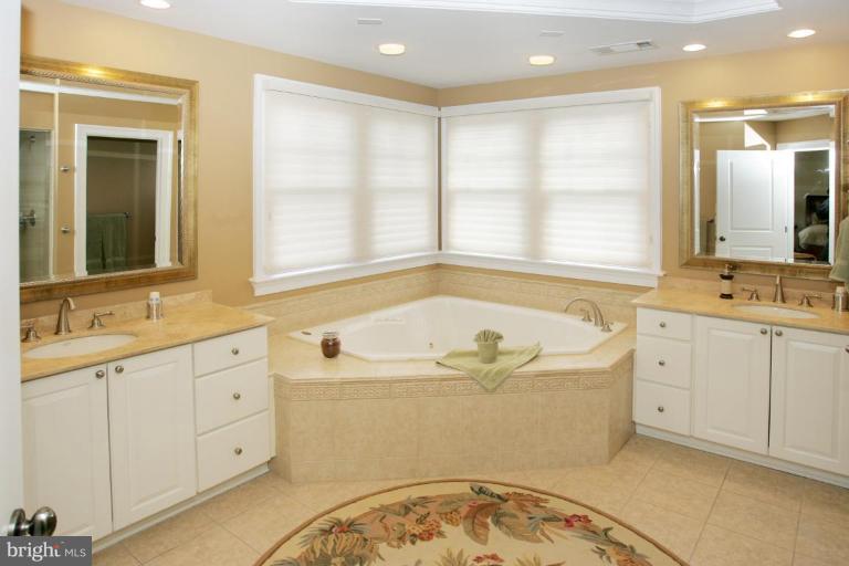 7105 Exfair Road Bethesda, MD 20814 - Photo 10 of 24 a bathroom with a tub sink and mirror