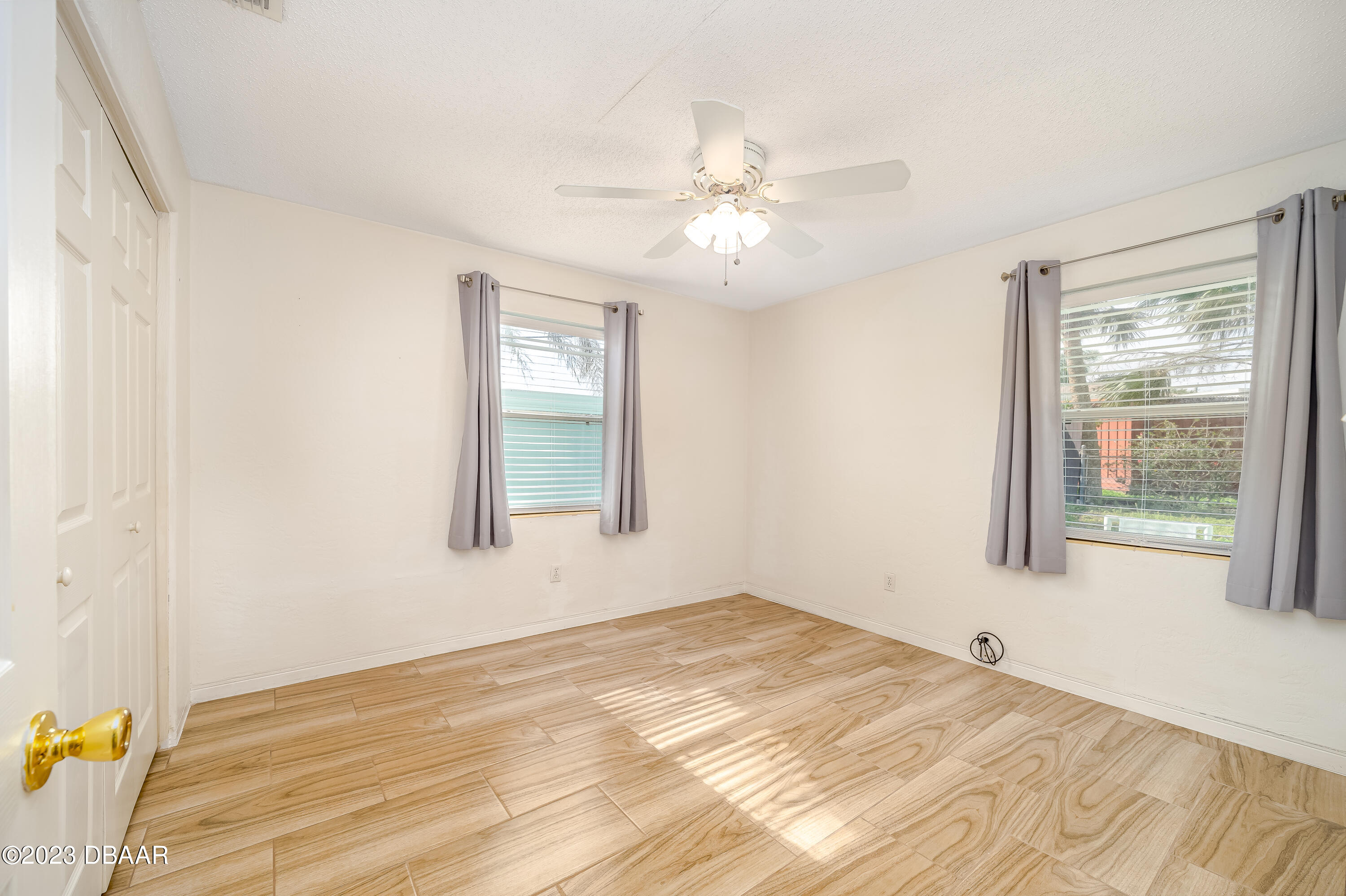19 Rivershore Drive Ormond Beach, FL 32176 - Photo 18 of 38 a view of an empty room with wooden floor and a window