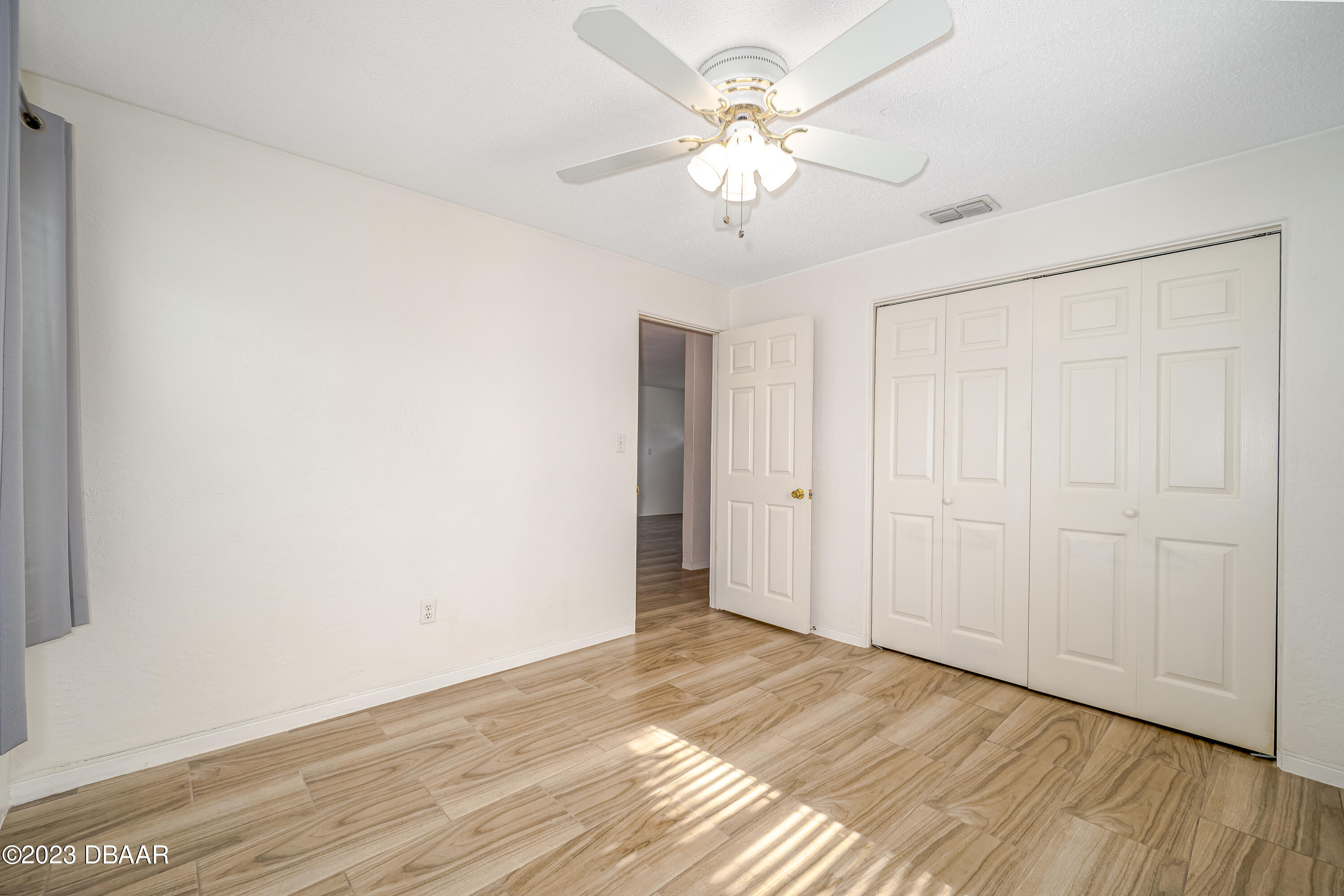 19 Rivershore Drive Ormond Beach, FL 32176 - Photo 19 of 38 a view of an empty room with wooden floor