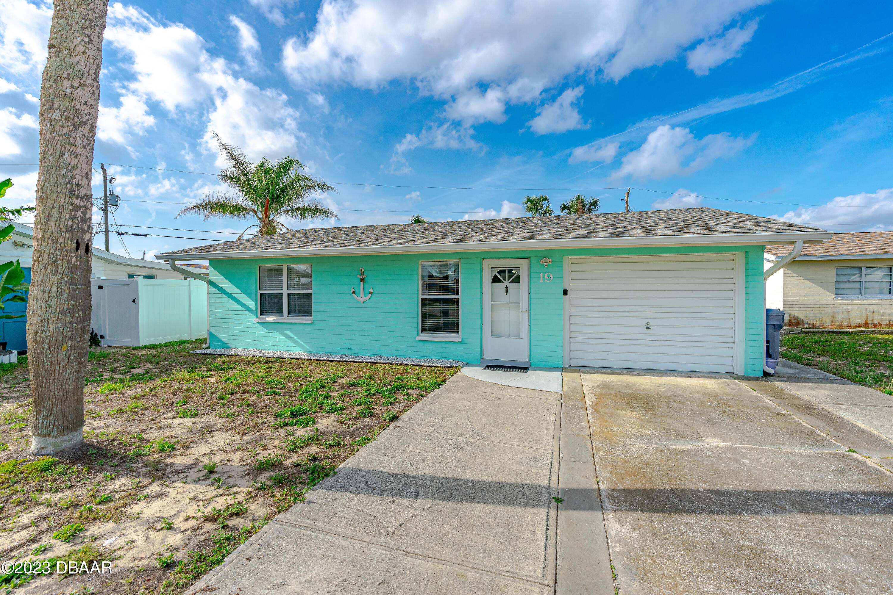 19 Rivershore Drive Ormond Beach, FL 32176 - Photo 2 of 38 a front view of a house with a yard and garage