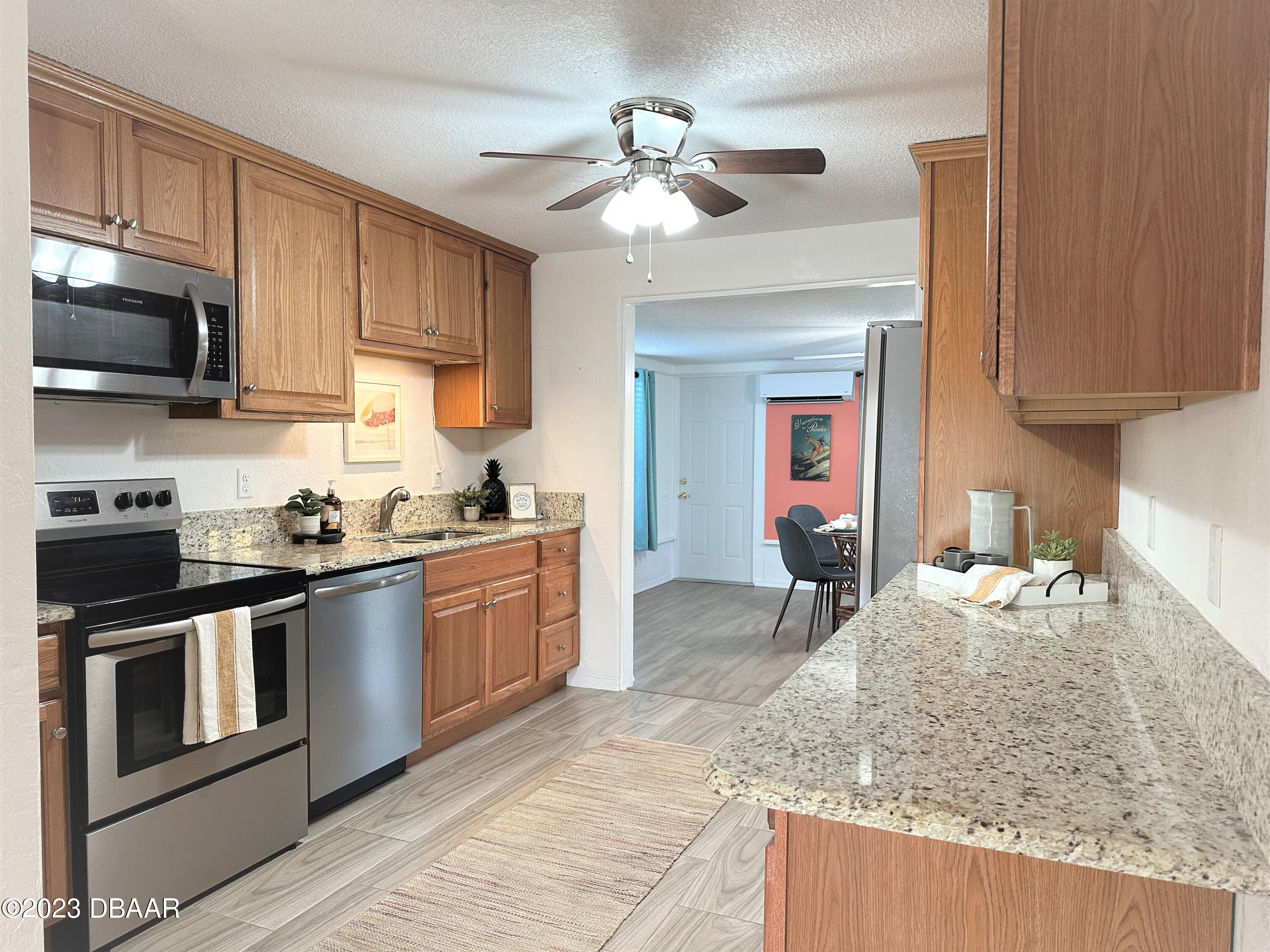 19 Rivershore Drive Ormond Beach, FL 32176 - Photo 10 of 38 a kitchen with stainless steel appliances granite countertop a sink stove and refrigerator