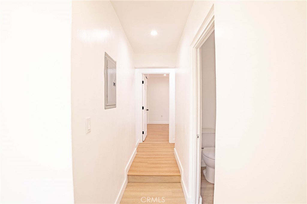13003 Kamloops Street Pacoima, CA 91331 - Photo 14 of 66 a view of a hallway with wooden floor