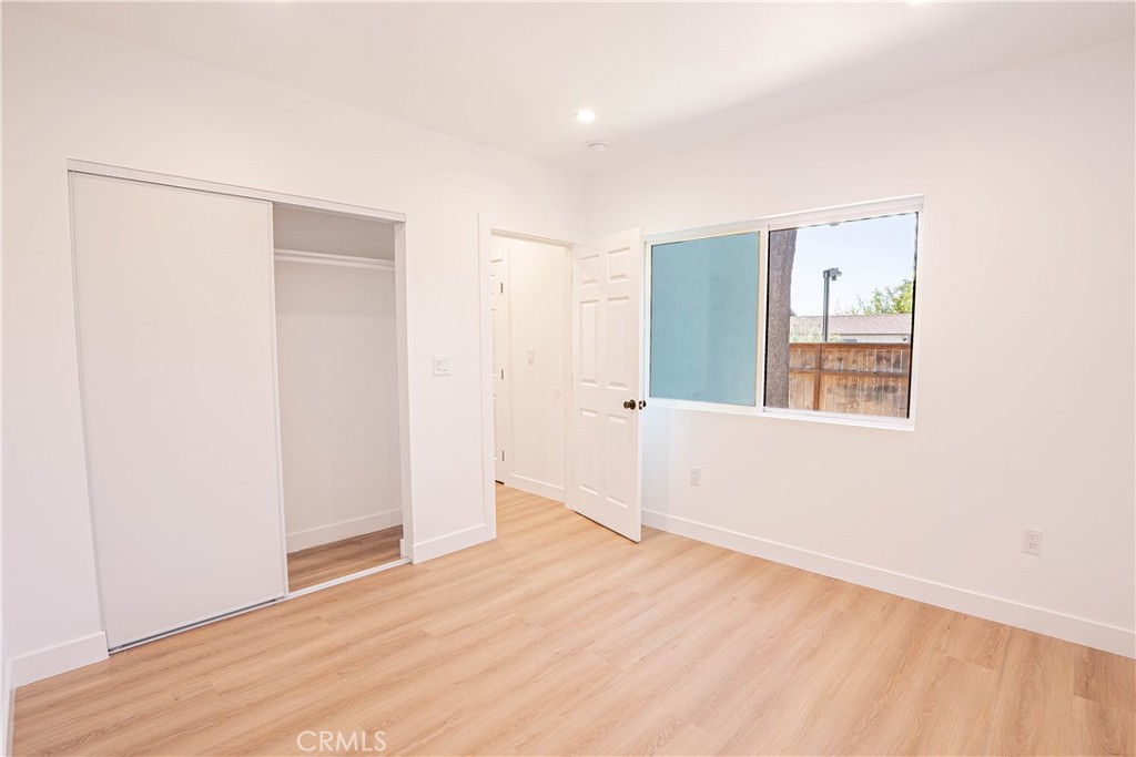 13003 Kamloops Street Pacoima, CA 91331 - Photo 19 of 66 a view of an empty room with wooden floor and a window