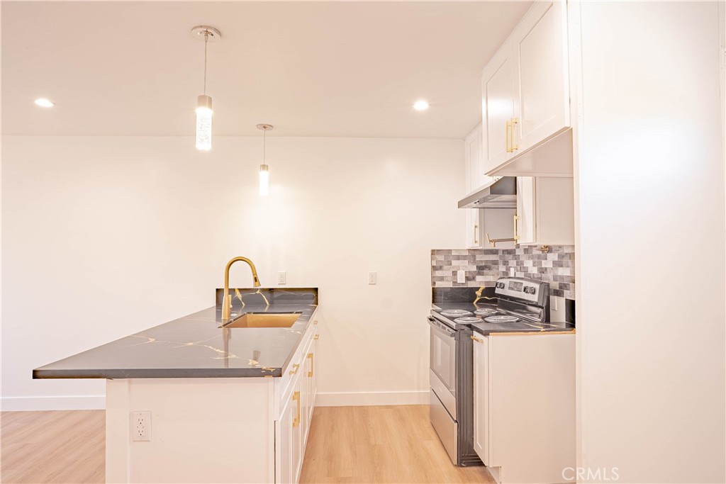 13003 Kamloops Street Pacoima, CA 91331 - Photo 25 of 66 a kitchen that has a sink and a stove
