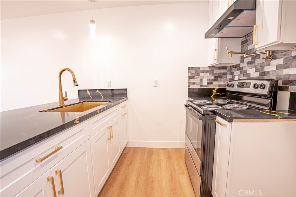 13003 Kamloops Street Pacoima, CA 91331 - Photo 26 of 66 a kitchen with a sink and a stove