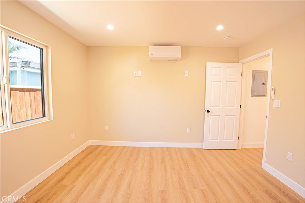 13003 Kamloops Street Pacoima, CA 91331 - Photo 30 of 66 an empty room with wooden floor and windows
