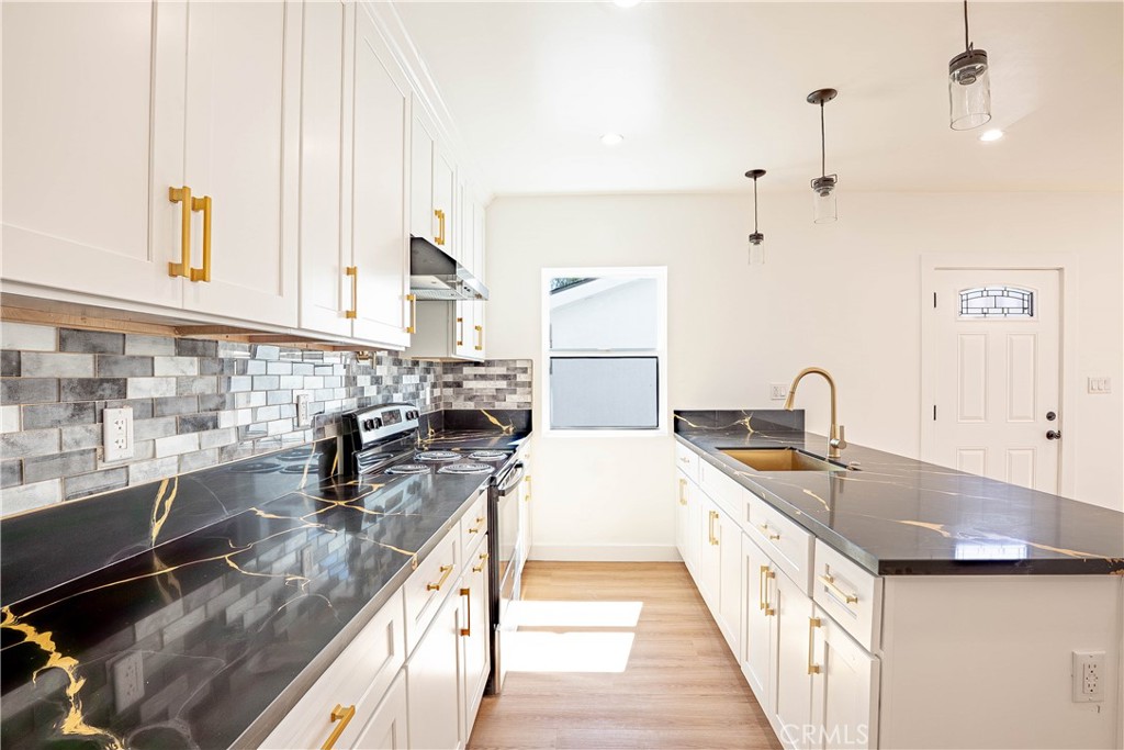 13003 Kamloops Street Pacoima, CA 91331 - Photo 38 of 66 a kitchen with sink and stove