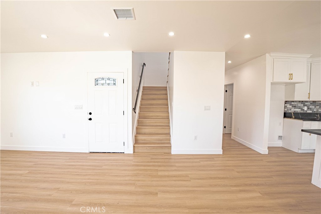 13003 Kamloops Street Pacoima, CA 91331 - Photo 40 of 66 a view of hallway with wooden floor