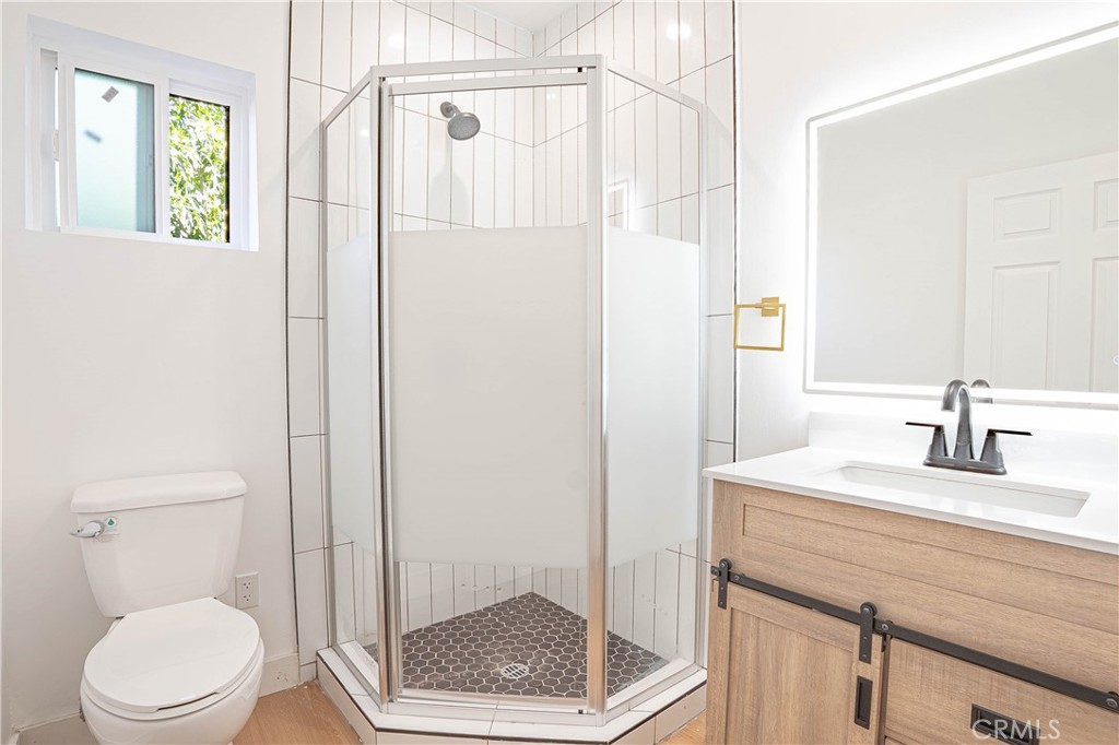13003 Kamloops Street Pacoima, CA 91331 - Photo 60 of 66 a bathroom with a sink a toilet and shower
