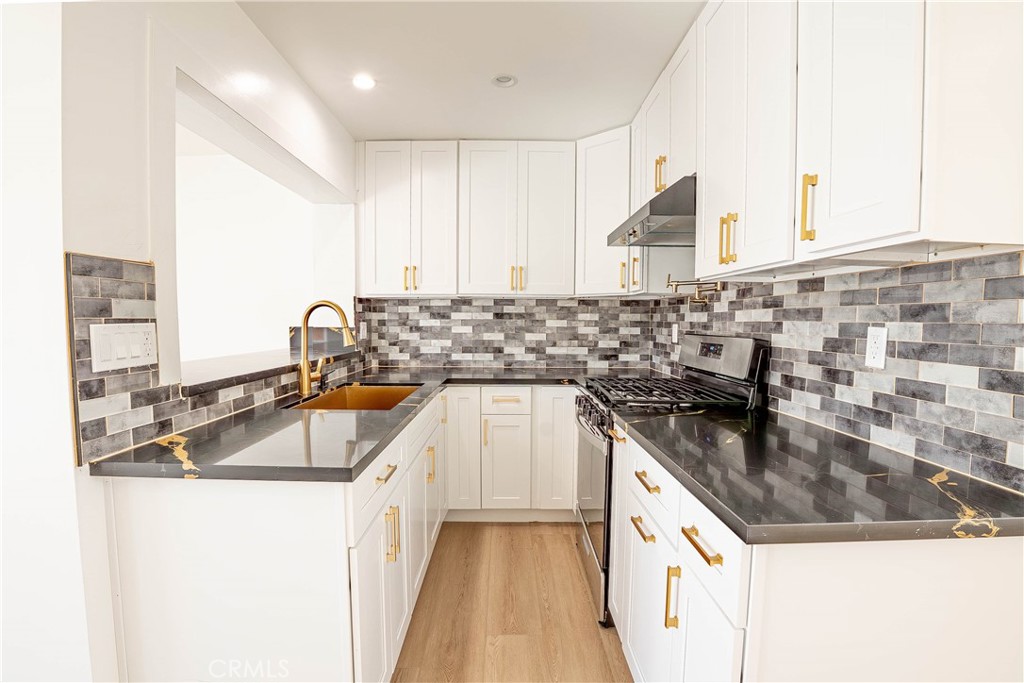 13003 Kamloops Street Pacoima, CA 91331 - Photo 6 of 66 a kitchen with kitchen island granite countertop a sink and a stove