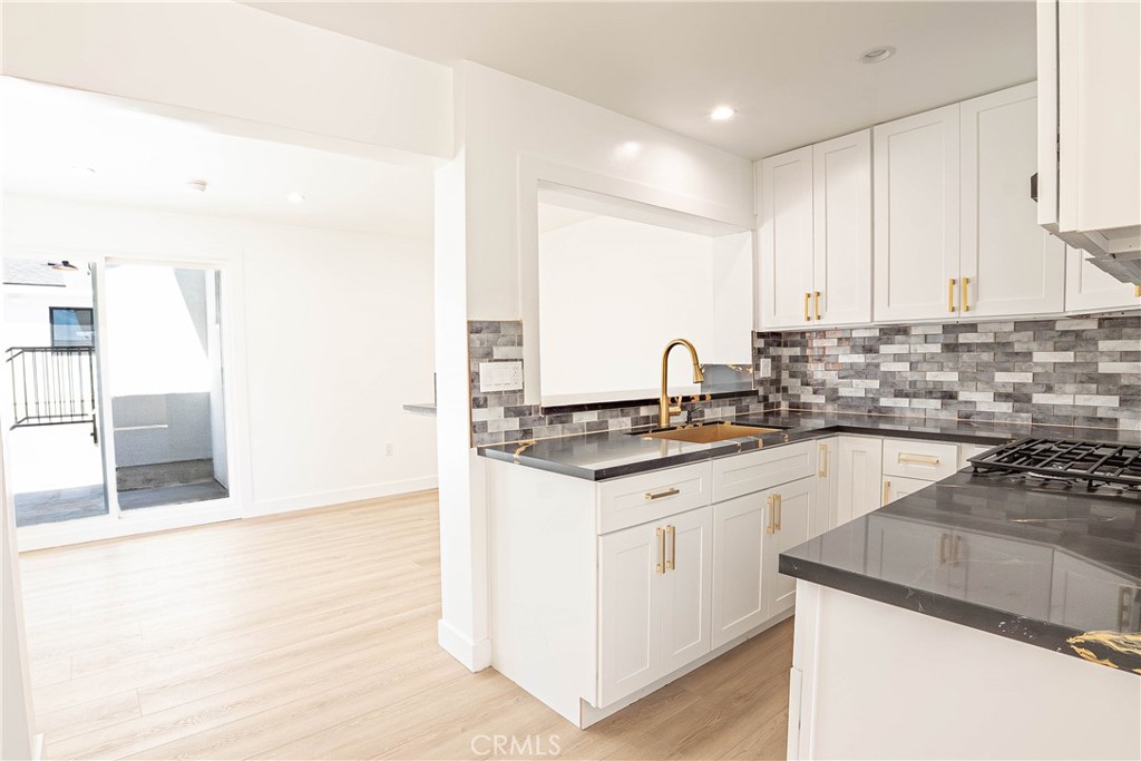 13003 Kamloops Street Pacoima, CA 91331 - Photo 7 of 66 a kitchen with stainless steel appliances granite countertop a sink stove and cabinets