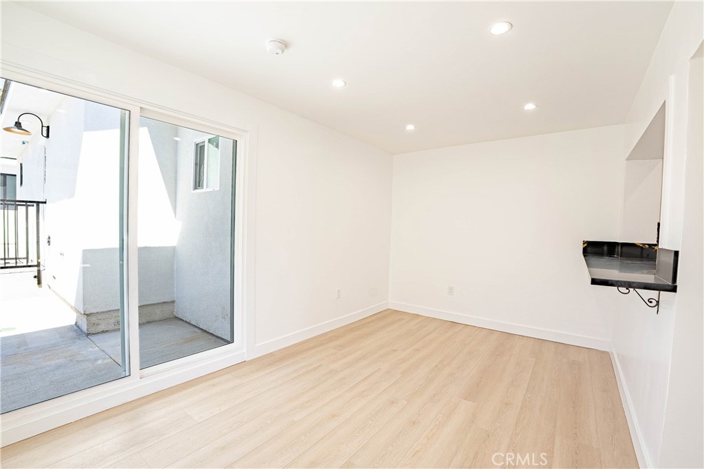 13003 Kamloops Street Pacoima, CA 91331 - Photo 8 of 66 a view of empty room with wooden floor
