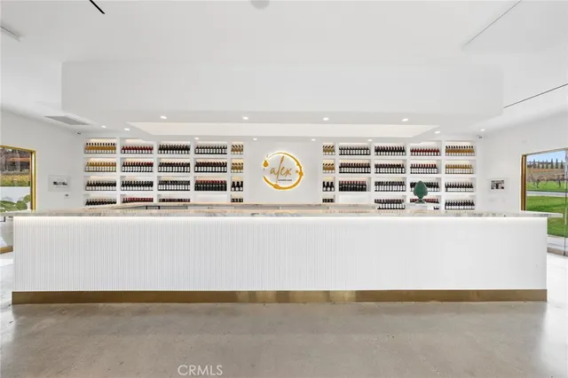 a bedroom with furniture large window and wooden floor