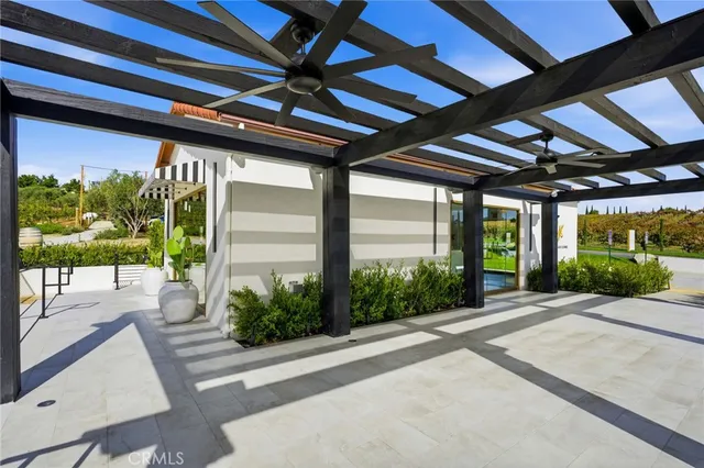 a porch with a furniture and garden view