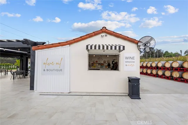 a spacious bedroom with a bed and a chandelier