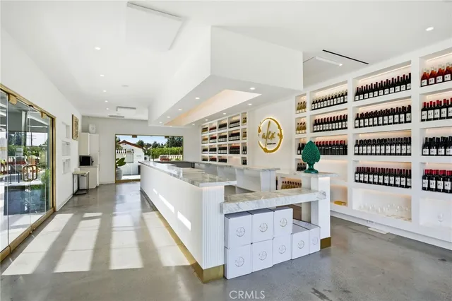 a large white kitchen with a large window and stainless steel appliances